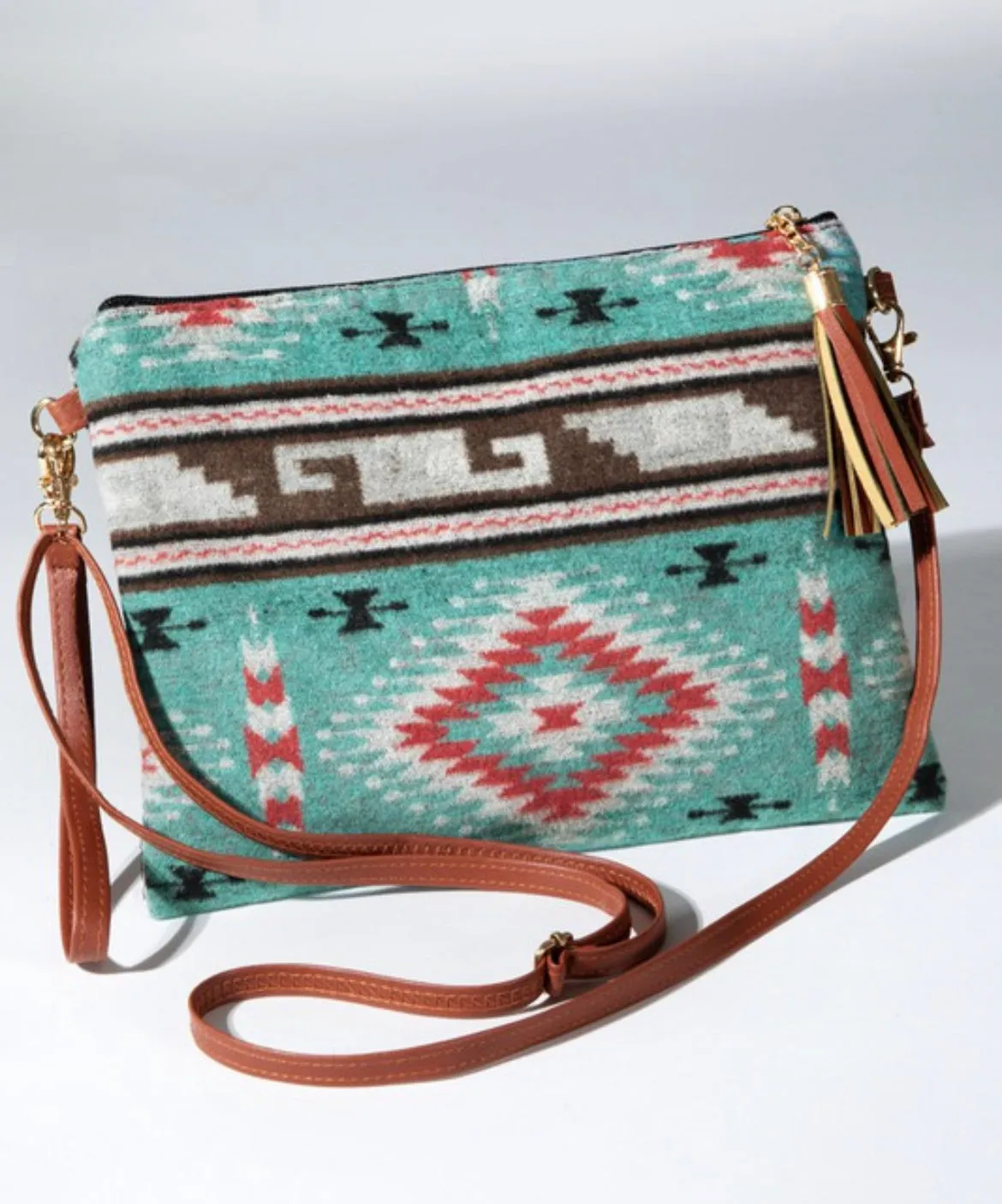 Turquoise western ethnic print with a detachable wristlet strap and tassel crossbody